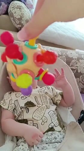 Baby playtime with colorful toys documented in Tobolsk, Russia