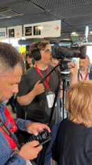 Inside a Gdańsk convention center during an active media event