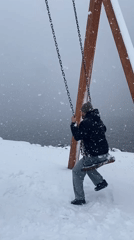 Man swings in heavy snowfall at Murmansk playground