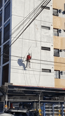 Building maintenance worker spotted cleaning facade in Buenos Aires