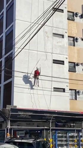 Building maintenance worker spotted cleaning facade in Buenos Aires