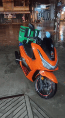 Heavy rain floods a Thai city street at night