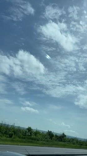 Rainbow streak spotted in clouds over Russian highway