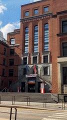 Milan afternoon walk captures labor building, historic pastry shop, dog