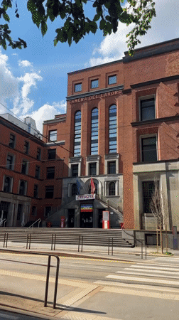 Milan afternoon walk captures labor building, historic pastry shop, dog