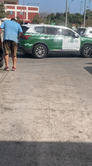 Man cleans police vehicle on Arica street