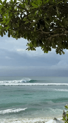Surfer catches waves at Kuta Selatan beach Sunday morning