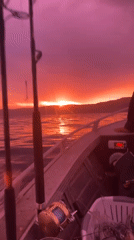 Fishing boat travels through colorful sunset waters near Wombarra