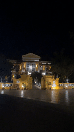 Illuminated grand mansion documented at night in Marna, India