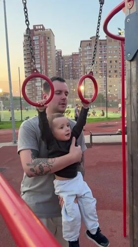 Family playground visit captured in Russian suburb during evening
