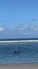 Person spotted in shallow water near green object, Kuta Selatan