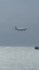 Morning beach scenes and low aircraft captured in Kuta