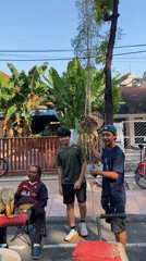 Community street fair with face painting, food vendors in Surabaya