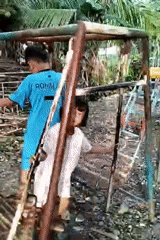 Children play on swings in Indonesian backyard after midnight