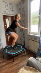 Woman exercises on mini-trampoline in Baranovka home workout session