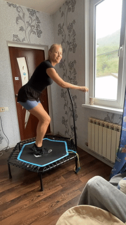 Woman exercises on mini-trampoline in Baranovka home workout session