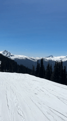 Skier descends slope at Whistler under clear skies