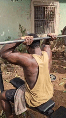 Men conduct outdoor weightlifting session with homemade equipment in Akwanga