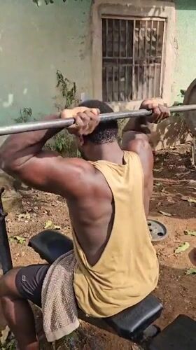 Men conduct outdoor weightlifting session with homemade equipment in Akwanga