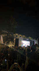 Outdoor crowd in Sofia watches soccer on a big screen