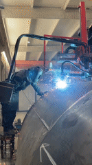 Welder works on metal dome in Montenegro industrial facility