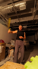 Nunchaku practice in a raw, unfinished room in Karaganda