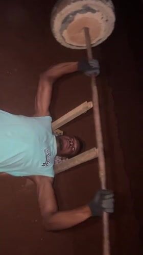 Man uses homemade gym equipment for outdoor workout in Bukuru
