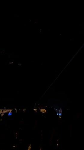 Nightclub crowd mingles under dynamic lighting in Sliven, Bulgaria