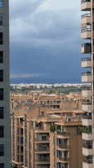 Storm clouds gather over València cityscape from elevated viewpoint