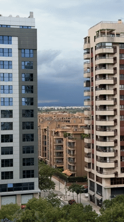 Storm clouds gather over València cityscape from elevated viewpoint