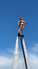 Tandem flyboarding fun on a sunny day at the water
