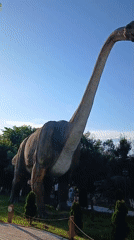 Exploring an outdoor dinosaur park with statues and live animals
