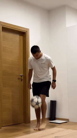 Man practices soccer juggling indoors in Montenegro apartment