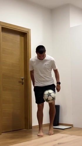 Man practices soccer juggling indoors in Montenegro apartment