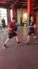 Pad work and sparring session in a boxing gym