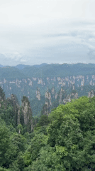 Tourist uses telescope at China's Wulingyuan Scenic Area