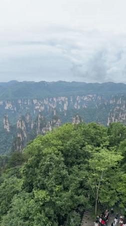 Tourist uses telescope at China's Wulingyuan Scenic Area
