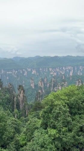 Tourist uses telescope at China's Wulingyuan Scenic Area