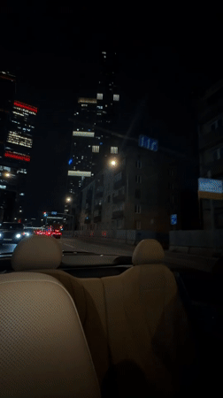 Night drive through Moscow in an open-top car