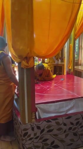 Buddhist monk creates art on decorated platform in Dharamshala