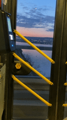 Bus passenger captures illuminated Varna waterfront view through door