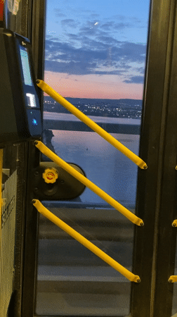 Bus passenger captures illuminated Varna waterfront view through door