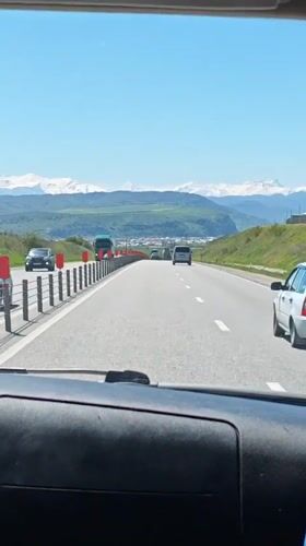 Highway travel documented near Baksan, Russia on sunny morning