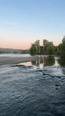 Rapids flow over rocks on river near Aya, Russia