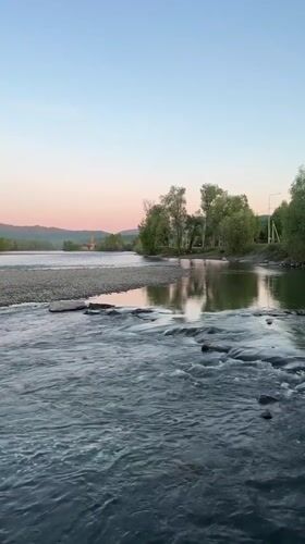 Rapids flow over rocks on river near Aya, Russia