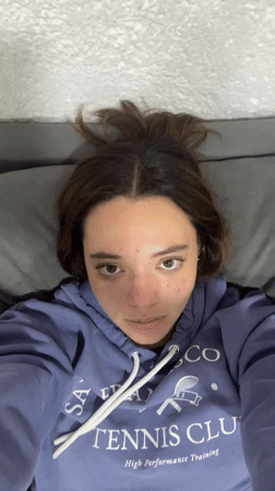 Two women share casual morning moment on couch in Cholula