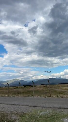 Plane passing over rural Montenegro near Podgorica Airport