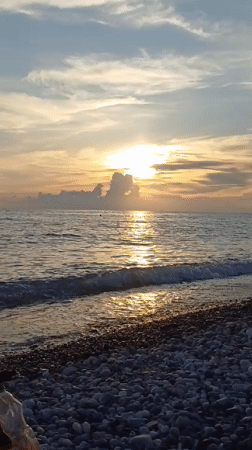 Sunset beach playtime on Sochi's pebble shore