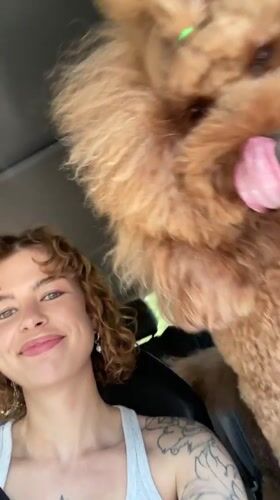 Woman films selfies with playful poodle in Montenegro