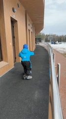 Child scooters near building amid winter scenes in Russia